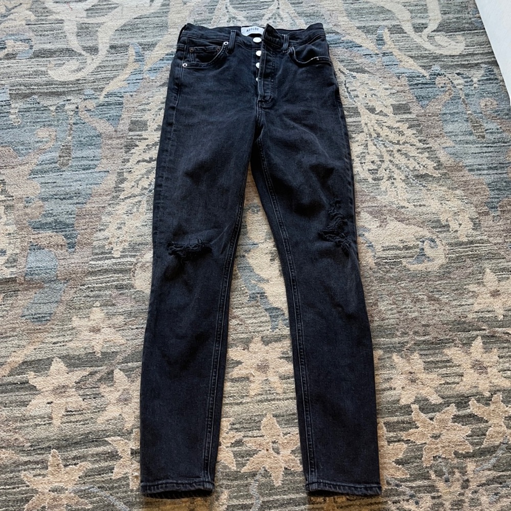 Black Agolde high rise ripped jeans.